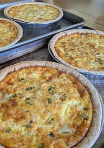 Mixed seafood quiche with shrimp, crab, and scallops in a golden crust