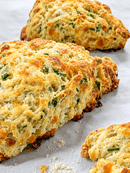 Freshly baked cheddar chive scones made with sharp cheddar cheese, fresh chives, and buttery flaky layers.