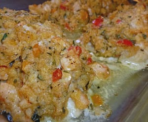 Oven-baked cod fillets topped with golden seafood stuffing made with shrimp, peppers, herbs, and buttery cracker crumbs, fresh from the oven