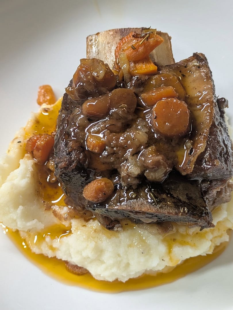 braised short ribs with red wine gravy over mashed potatoes
