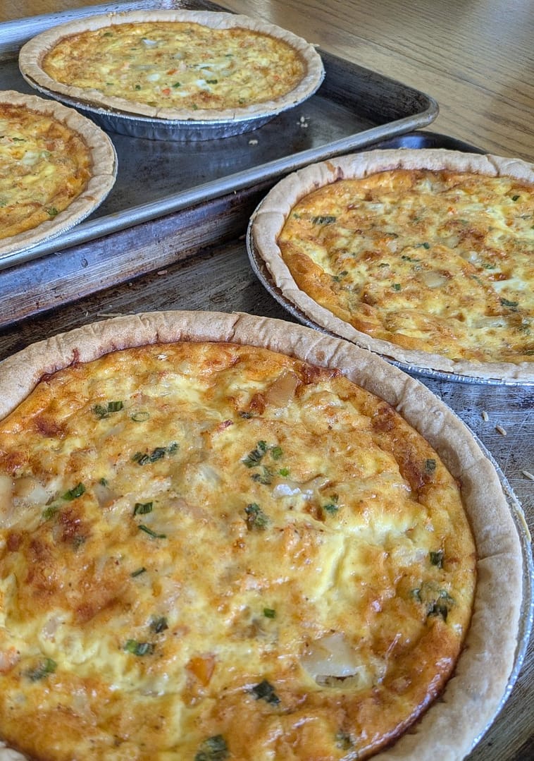 Mixed seafood quiche with shrimp, crab, and scallops in a golden crust